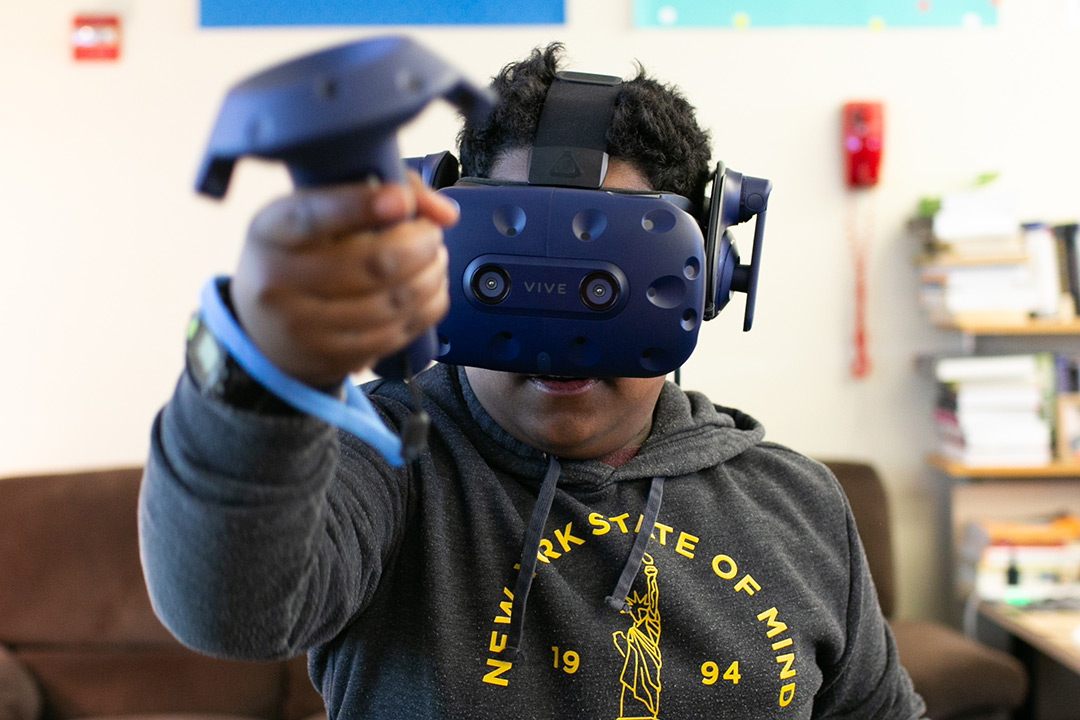 Student wears virtual reality goggles.