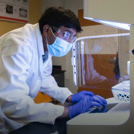 Student working with lab equipment