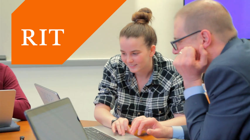 Students and professor work on laptops.