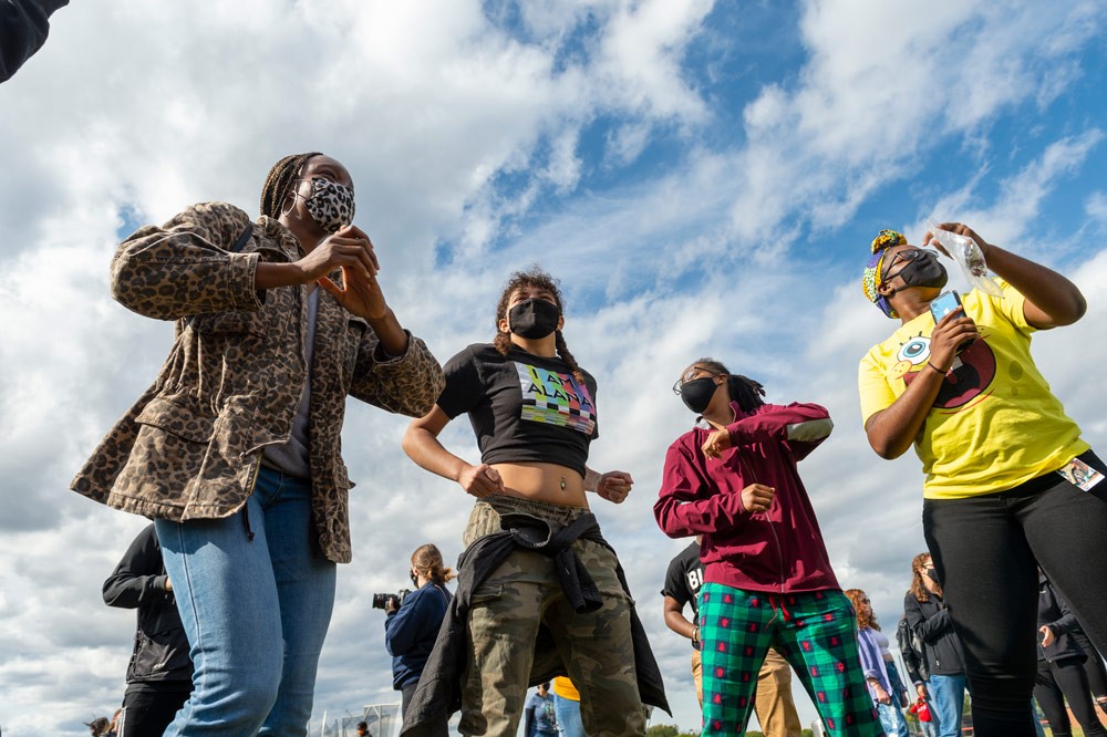 Students dancing with blue skies