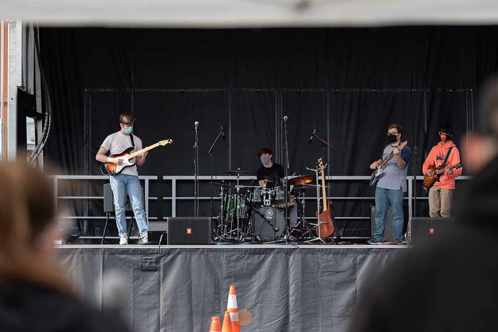 students in a band performing on stage.