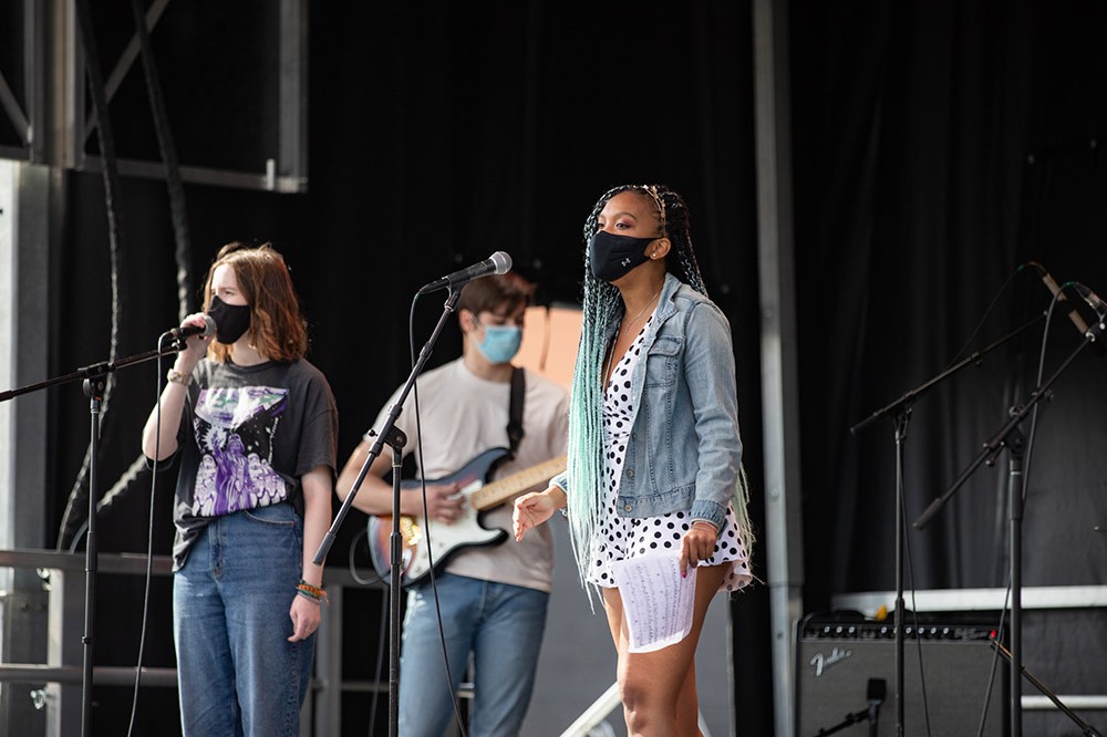 students performing on stage.