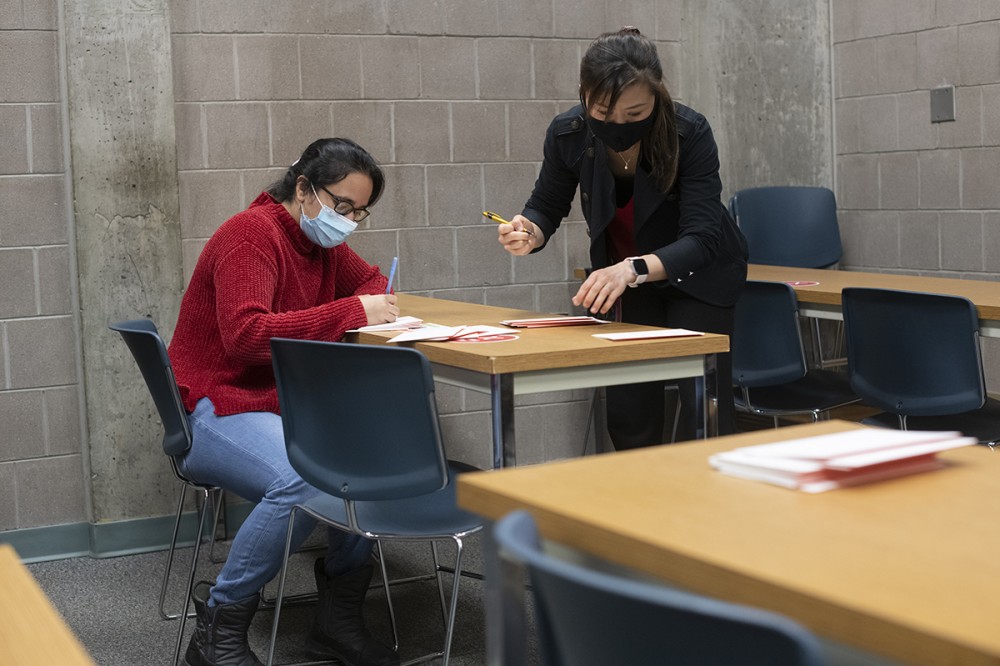 two females writing notes