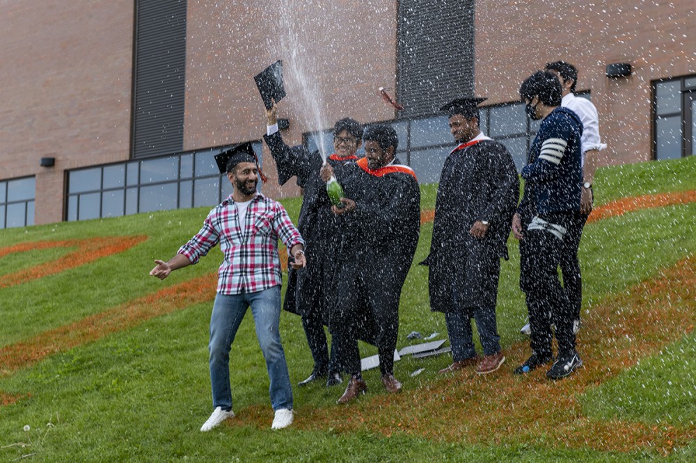 male graduates celebrate