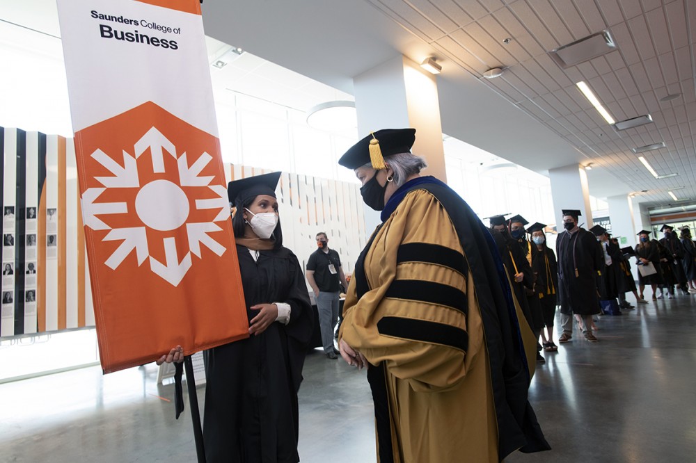 Graduate holding banner