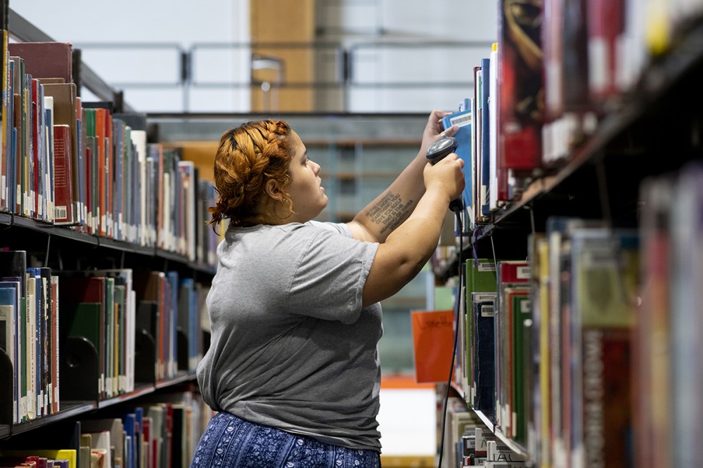 student scanning books