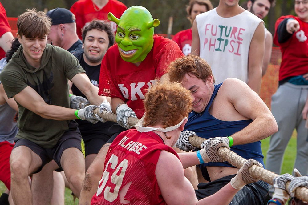 team pulling a rope in a tug of war contest.