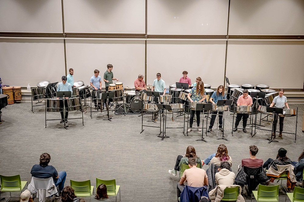 students playing steel drums and other percussion instruments.
