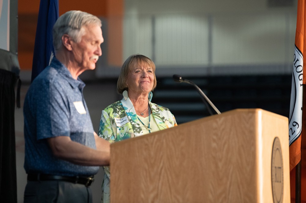 two people standing at a podium.