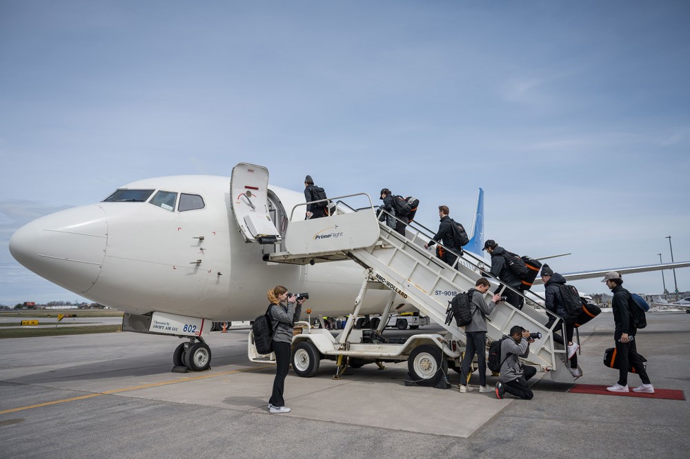 Members of the RIT mens hockey team board a charter plane to Sioux Falls, S.D., where they will play Boston University in the NCAA playoff game on Thursday. 