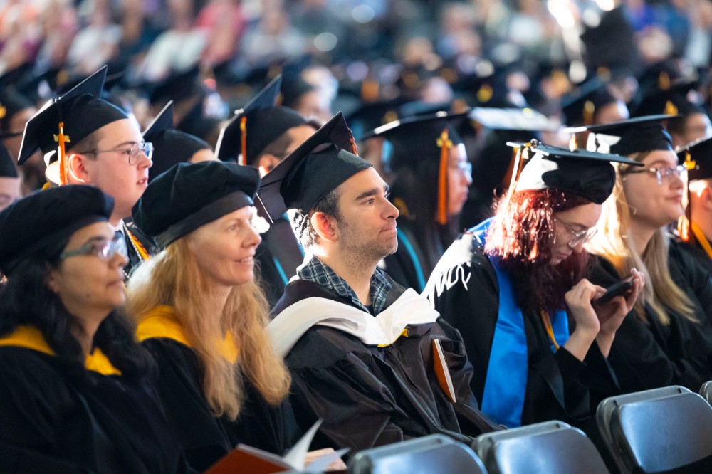 students sit inside the Gordon Fieldhouse for commencement.