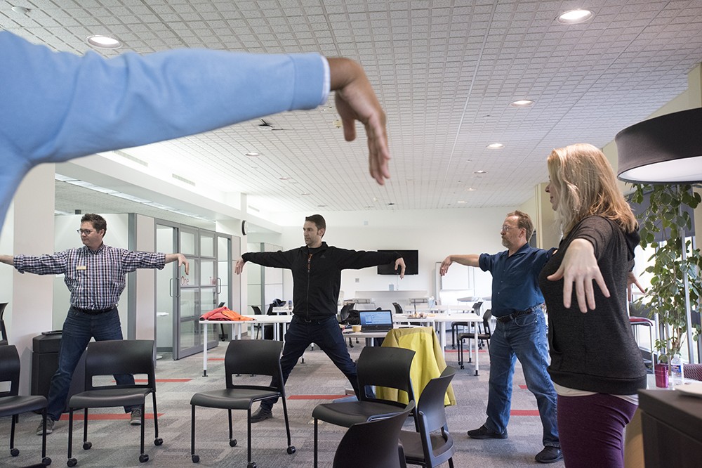 Faculty doing yoga exercises