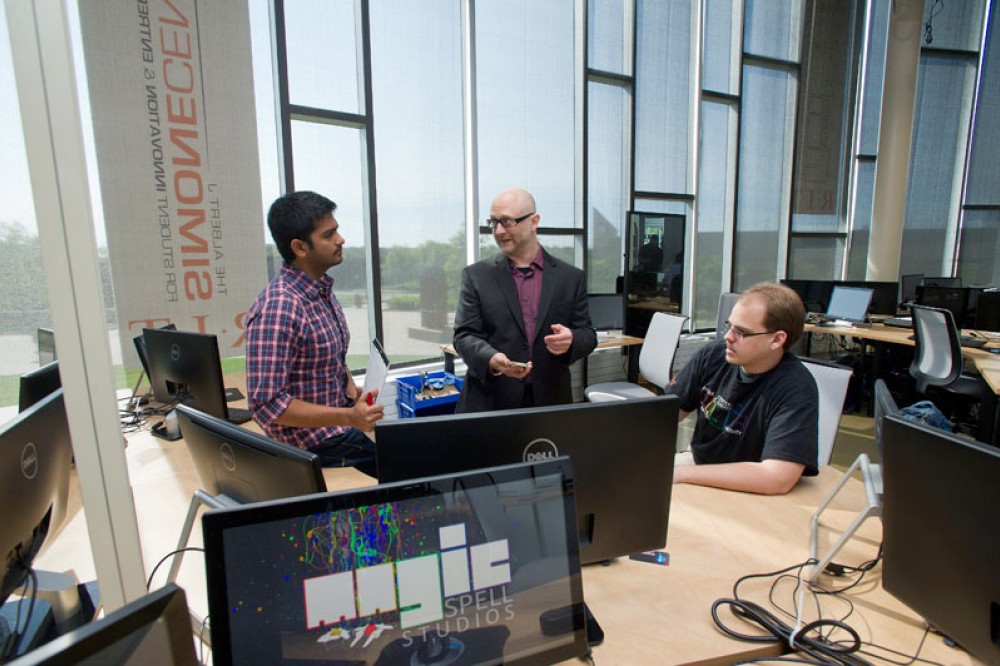 <p>Assistant Professor Owen Gottlieb, center, leads the MAGIC Center’s Religion, Culture, and Policy Initiative, which cultivates research that focuses on games, religious literacy, the acquisition of cultural practices and the implications for policy and politics. Here, Gottlieb works with graduate students Lakshminarayanan Vijayaraghavan, left, and Alex Lobl on the initiative project, Codename: Purple, a tabletop card-to-mobile strategy game currently in development that teaches literacy in medieval religious legal systems. Beginning with a medieval Jewish law code and built modularly to incorporate Muslim and potentially other neighboring sacred law systems, the game will provide live cases modeling religious systems for communal cooperation and collaboration. For more information, go to magic.rit.edu/rcp.&nbsp;</p>
