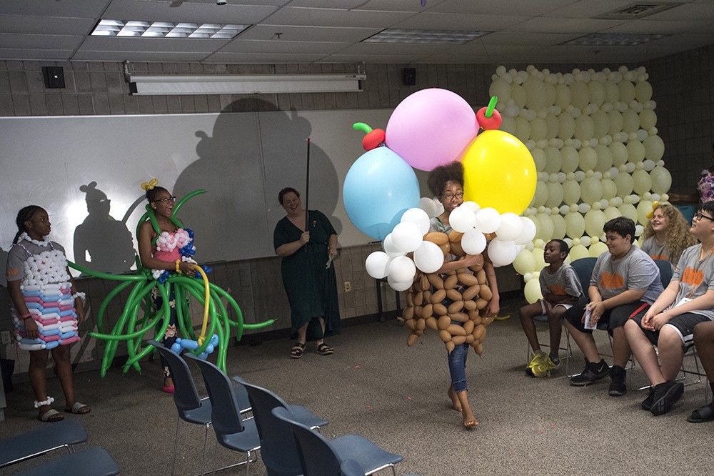 <p>Varnette Okai, a seventh-grader at Olympia Middle School, shows off her ice cream cone design composed of balloons.&nbsp;RIT’s Liberty Partnerships Program's&nbsp;workshop with Kelly Cheatle&nbsp;('98, '99 illustration and graphic design),&nbsp;artistic director at Airigami <a href="https://www.airigami.com/">https://www.airigami.com</a>, ended with a fashion show of costumes created with balloons.&nbsp;<span><span><span><span><span><span><span><span><span><span><span><span><span><span><span><span><span><span><span><span><span>RIT’s Liberty Partnerships Program is part of the New York State Education Department’s Statewide Plan for Higher Education. The program's goal is to increase high school graduation rates.</span></span></span></span></span></span><span></span></span></span></span></span></span></span></span></span></span></span></span></span></span></span></span></p>
