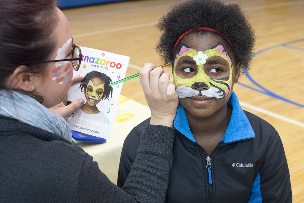 <p><span><span><span><span><span><span><span><span><span><span><span><span><span><span><span>RIT graduate student Marissa Dreibelis paints a cat design on&nbsp;10-year-old Antasia McFee during a community outreach event at the Avenue D Recreation Center in Rochester.</span></span></span></span></span></span></span></span></span></span></span></span></span></span></span>&nbsp;Students from RIT's Master of Science for Teachers - Visual Arts All Grades (Art Education) program work with Rochester city children and their families during a fall "Community Art Bash." The annual outreach project is a collaboration between the School of Art in RIT's College of Art and Design, MST Program, Joseph Avenue Arts and Culture Alliance, and the City of Rochester's Recreation Bureau. The outreach is geared toward children and families from Rochester's underserved Northeast Quadrant.&nbsp;</p>
