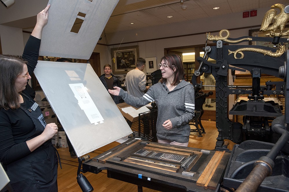 <p>Associate Curator Amelia Hugill-Fontanel ’02 MS (printing technology), assisted Adrianna Petrus, a graduate student in visual communication design from Lyons, N.Y., with a print on the historic Kelmscott/Goudy printing press. The Cary Graphic Arts Collection celebrated 50 years with an exhibit, reception and a commemorative printing on the Kelmscott/Goudy printing press.</p>
