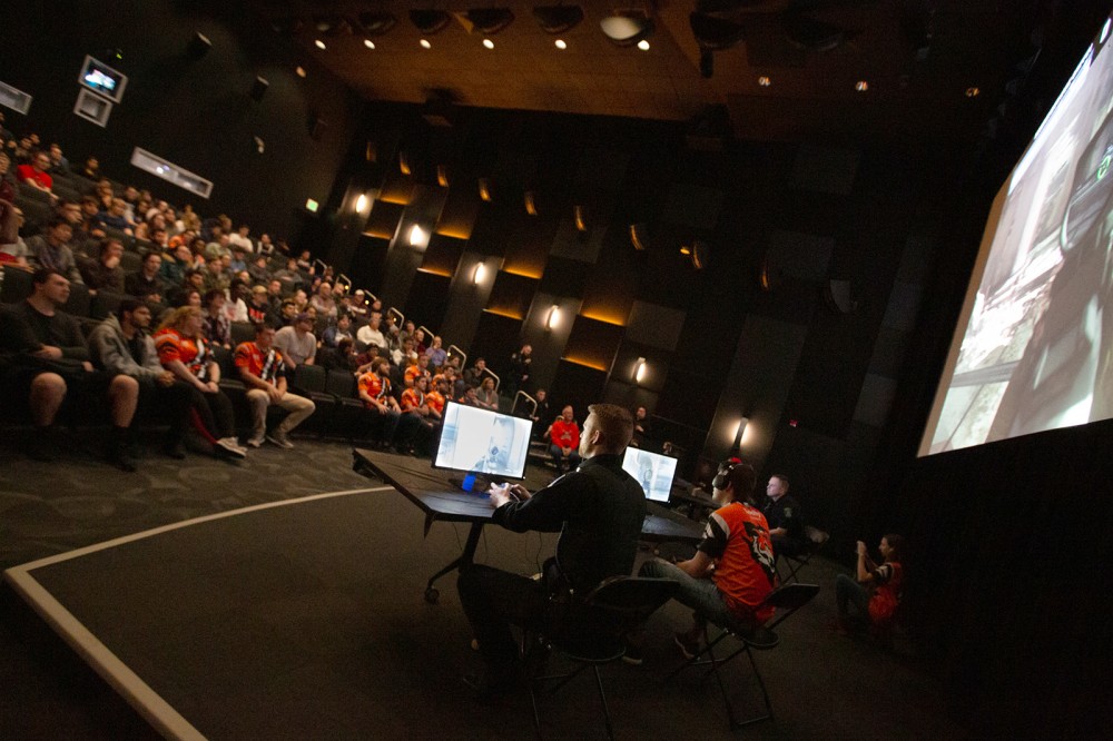 People on stage in theatre, audience in background