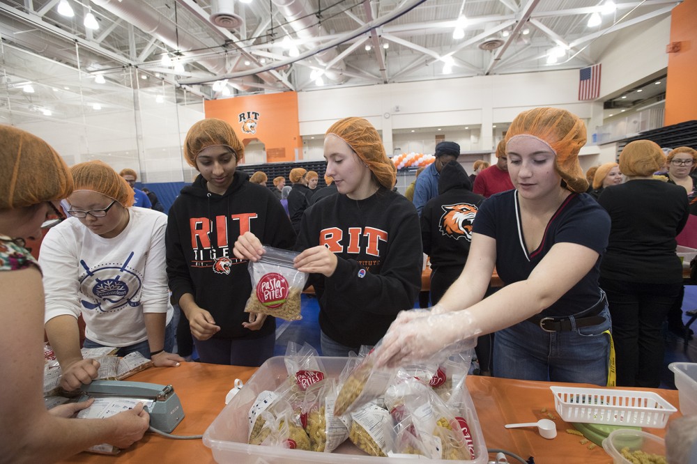 students preparing food packages
