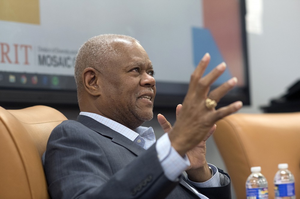 man speaking, gesturing