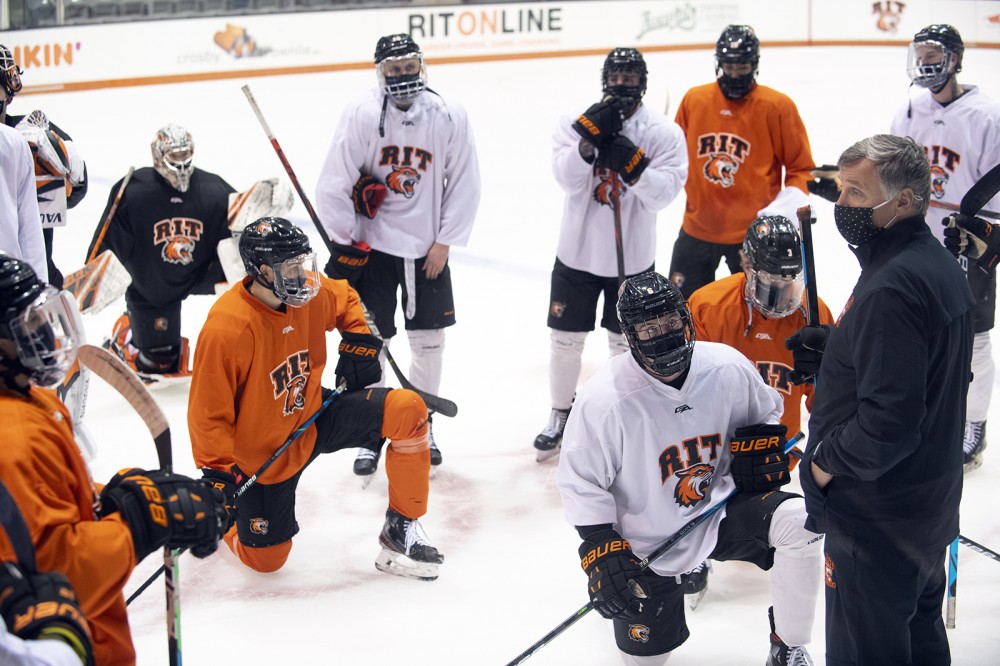 hockey players listening to coach
