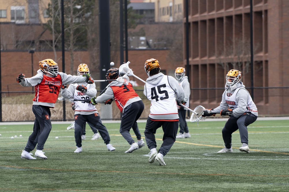 group of athletes playing lacrosse.