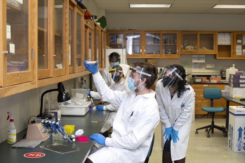 student and faculty in lab.