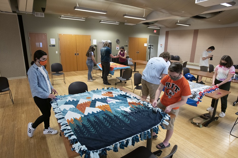 students making no-sew fleece blankets.