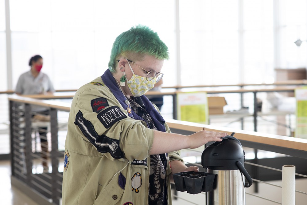 student watering plant