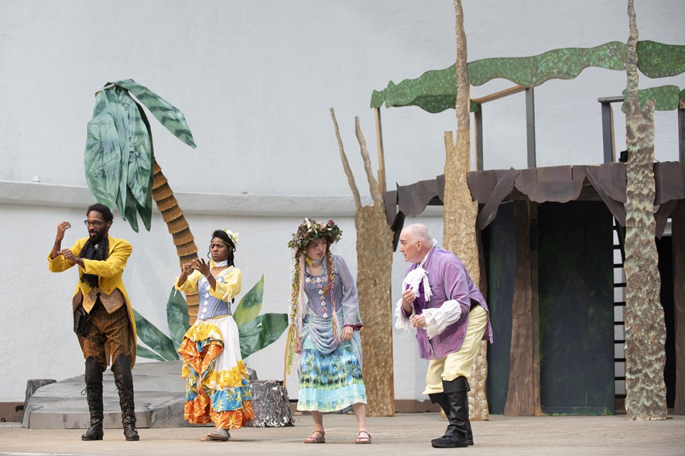 four actors on stage portraying a scene from The Tempest.