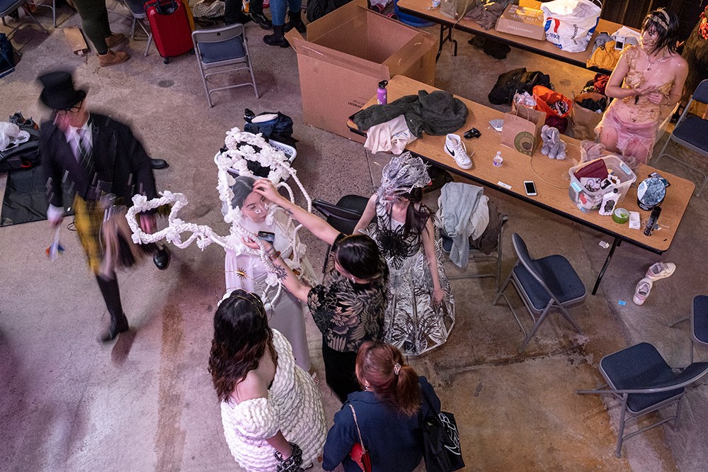 overhead view of models getting ready at fashion show.