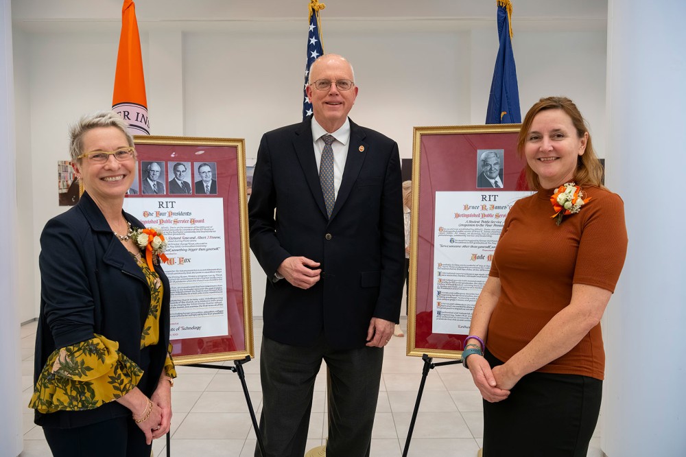 <p>RIT President David Munson, center, emceed the 2023 Alfred L. Davis Public Service Awards on April 11. Recipients Susan Fox, left, and Jade Myers, right, were honored for their outstanding record of service. The Four Presidents Distinguished Public Service Award was presented to Fox, a prospect researcher in University Advancement, for her commitment to the Rochester community through volunteering for the Dining Room Ministry program run by Third Presbyterian Church, and the East Avenue Grocery Run, an annual event that has raised more than $400,000 for 24 food pantries and meal programs. A gift in Fox’s name will be made to the grocery run. The Bruce R. James ’64 Distinguished Public Service Award was given to Myers, a mechanical and industrial engineering doctoral student in RIT’s Kate Gleason College of Engineering, who focuses on designing prostheses for individuals who have lost limbs. A gift in Myers’ name will be made to the Healing Hands for Haiti Foundation.</p>
