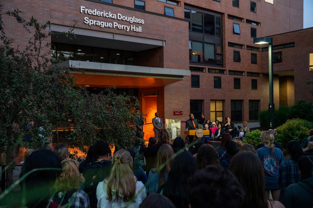 Keith Jenkins, senior vice president and associate provost for Diversity and Inclusion, speaks Thursday at a commemoration to rename an RIT residence hall after a granddaughter of abolitionist Frederick Douglass. The dedication of Fredericka Douglass Sprague Perry Hall was held in conjunction with RIT’s annual Lighting the Way ceremony to welcome women and non-binary students to campus.
<br><p>Photo by Travis LaCoss</p>
