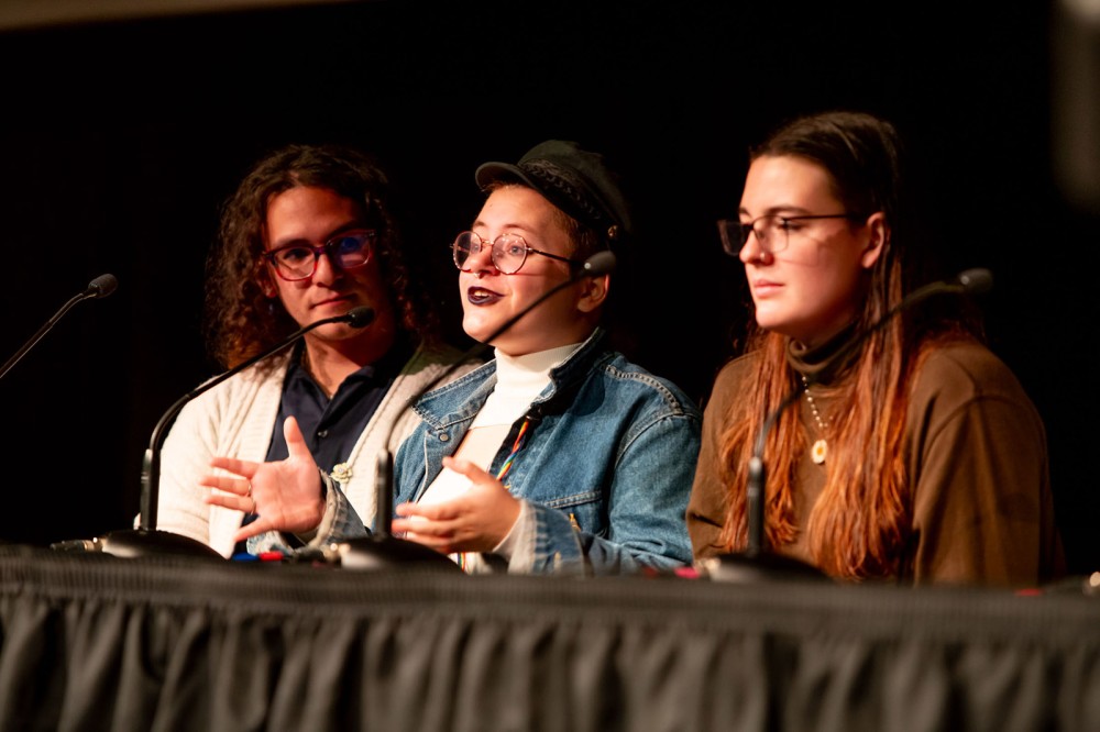 The second annual Together RIT: A Day of Dialogue, hosted by the Division of Diversity of Inclusion, was held on Oct. 20 and focused on gender and sexuality. Student Peter Zellers, center, speaks during the opening panel held in Ingle Auditorium alongside staff interpreter Jase Rivera, left, and student Leah Dibble, right.
<br><p>Photo by Scott Hamilton</p>