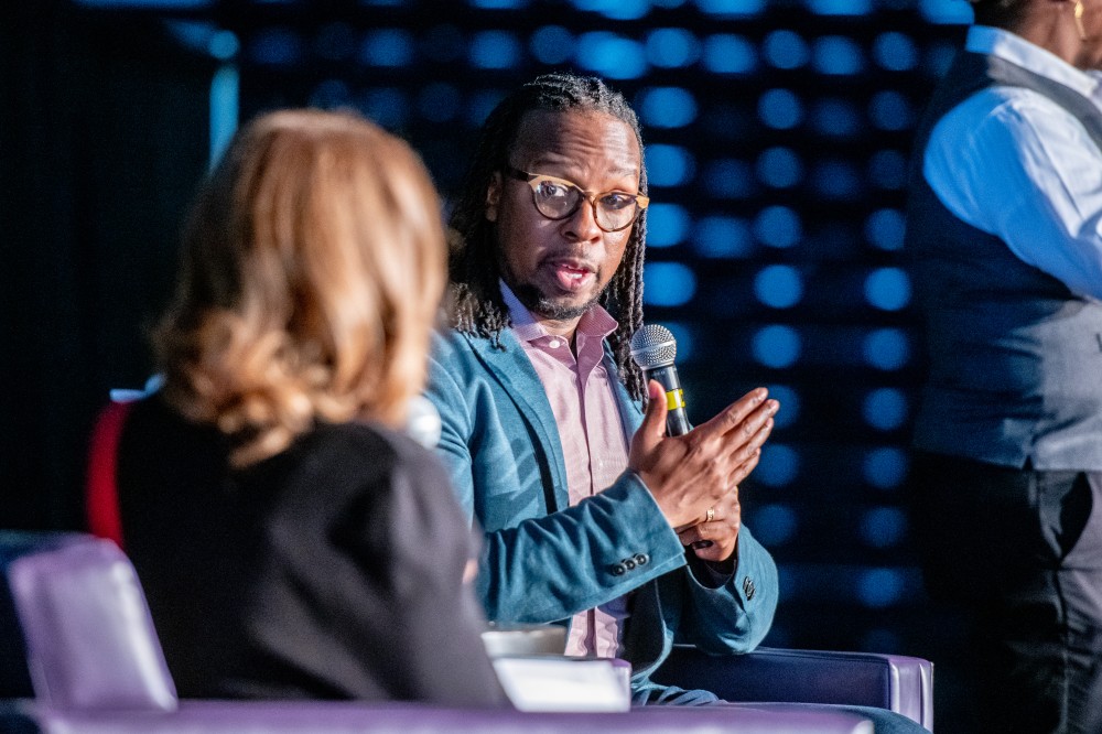 Ibram X. Kendi sits on a stage with a moderator at this year’s Expressions of King’s Legacy event.