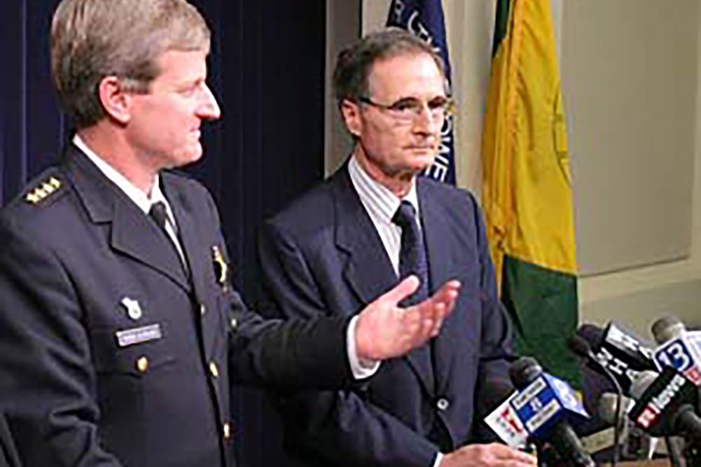 Monroe County Sheriff Patrick O'Flynn, joined by RIT President Albert Simone, announced two arrests in RIT's Crossroads robbery. Both men addressed the media during a news conference. Dwight Rutley, a temporary employee at Crossroads, and Travis Rutley are charged with robbery and assault for their part in the Oct. 4 incident. The search continues for another suspect.