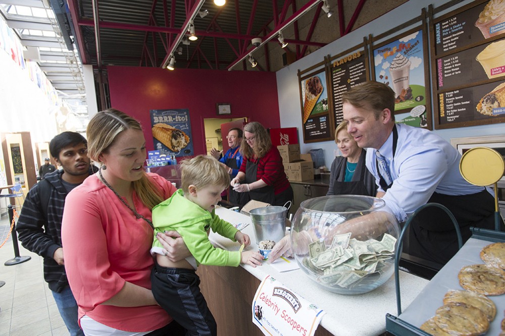 Celebrity ice cream scooper Matt Marshall, associate dean in the Kate Gleason College of Engineering, serves
3-year-old Jack Fox with his mother, Becki Schicker, manager of donor relations at United Way of Greater Rochester.
The activity was part of the Fuel the Fun Carnival Day kickoff for the 2017 RIT United Way Campaign.
To make your online pledge, go to <a href="http://www.rit.edu/unitedway/">rit.edu/unitedway</a>.