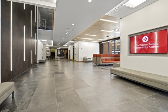 an atrium with a tiled floor and long benches.