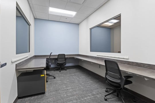 a lab room with two-way mirrors and a ledge around the space.