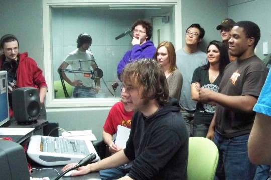 A group of students recording in the audio control room