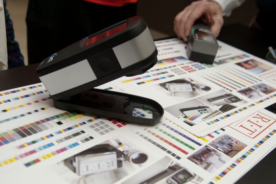 A color checker tool on printed paper.