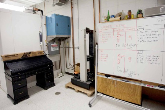 A movable whiteboard next to a large piece of equipment