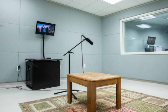 Sound recording room with an empty table on a carpet 