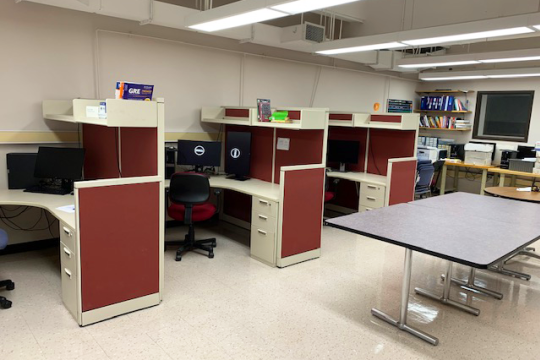 Desk stations with computers at each. 