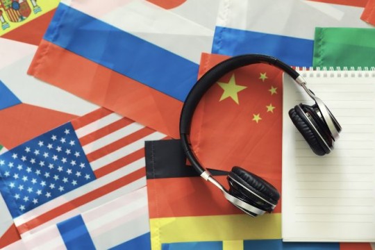 a photo of flags with headphones and a notebook