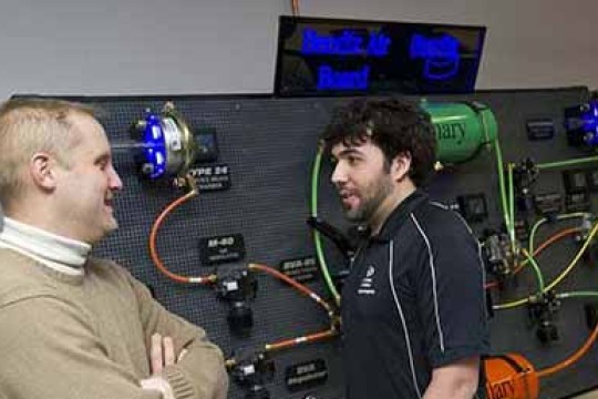 Two people in the Knorr-Bremse Mechatronics Laboratory.