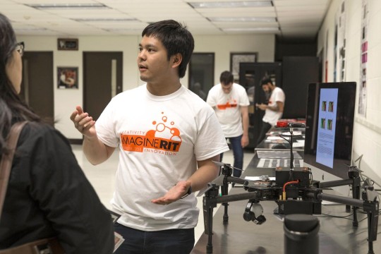 Student demonstrating his drone at Imagine RIT