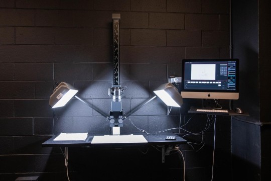Stop motion set in a black room with 2 bright lights shining on a white canvas
