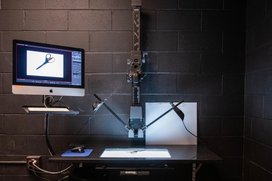 Stop motion set in a black room with 2 bright lights shining on a white canvas