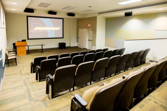 Classroom with stadium seating and a large projector