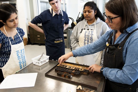 Students work in the Cary Press space in RIT's SHED facility.